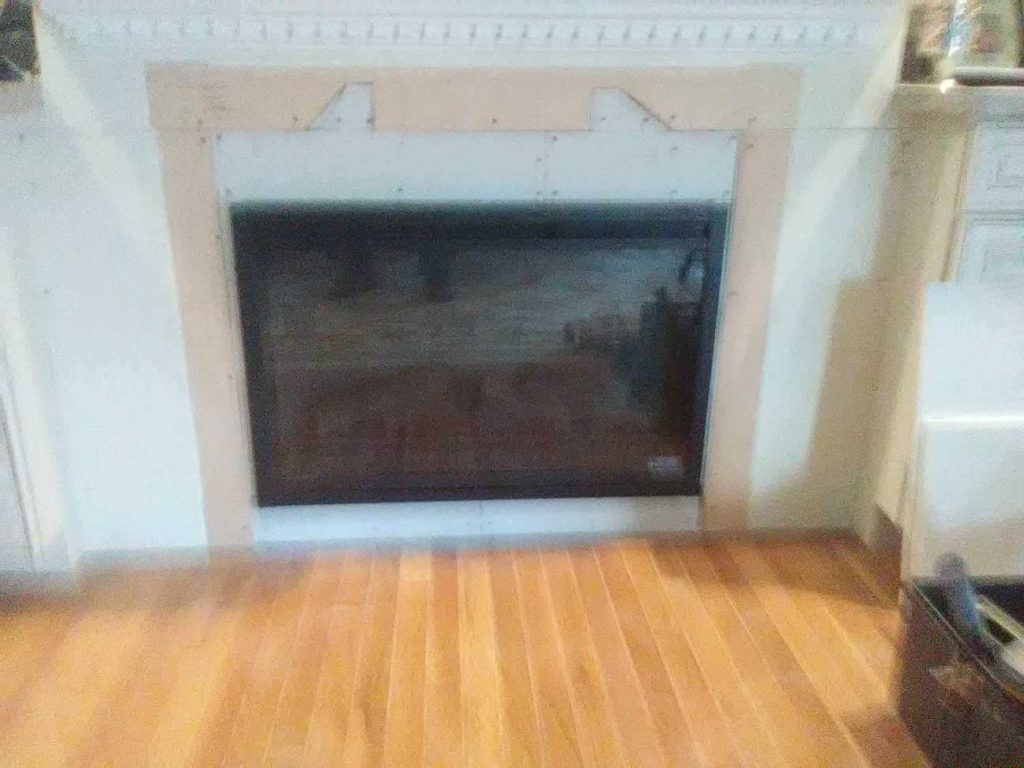 Plain fireplace wall before a custom mantle in Winchester, VA