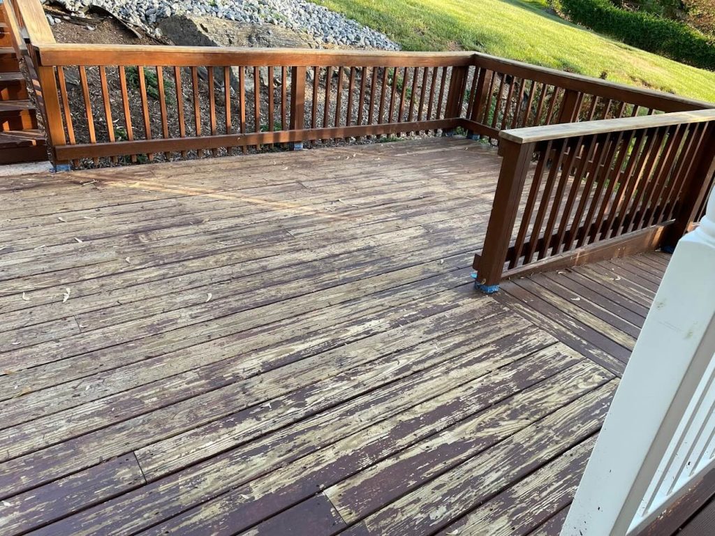 Weathered, peeling deck with worn boards before rebuilding in Winchester, VA